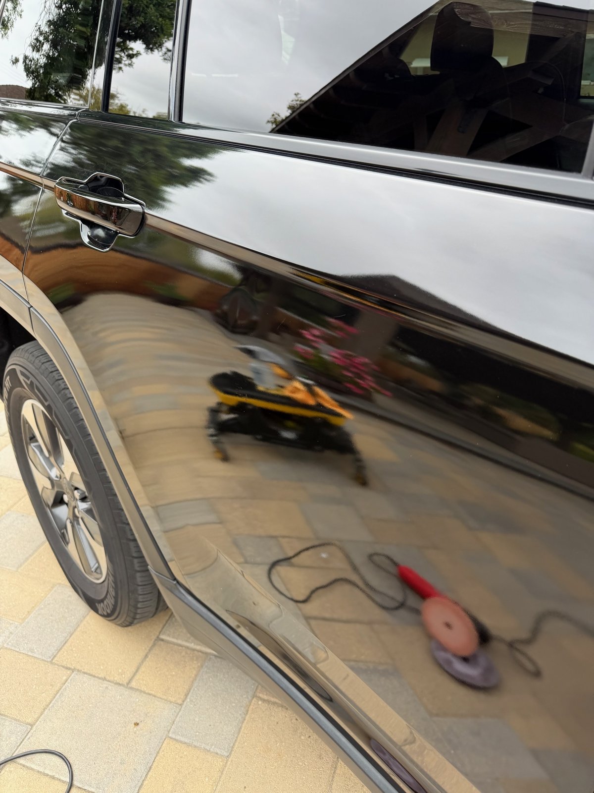 Same black paint after correction, sharp mirror-like reflection