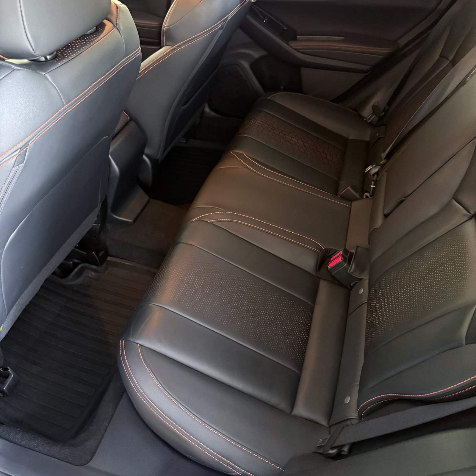 Clean black leather rear seats with contrast stitching