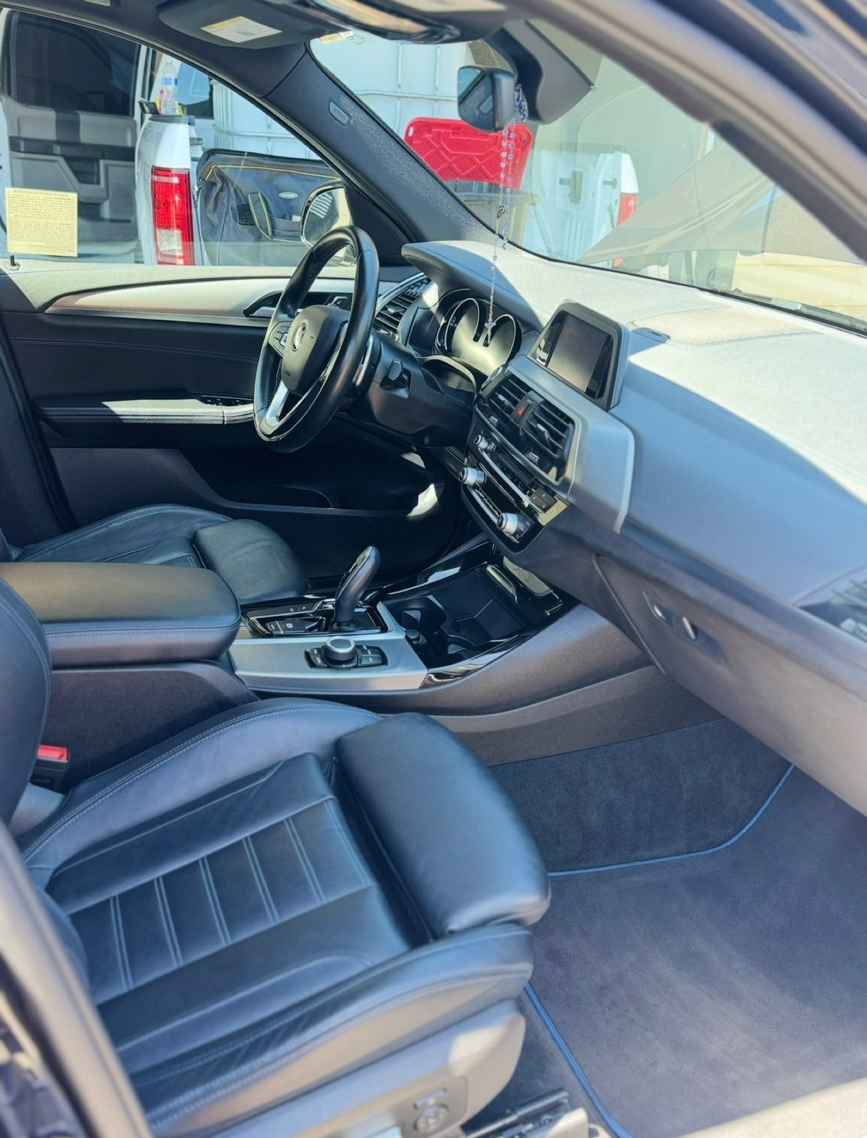 Clean BMW SUV interior dashboard after detailing