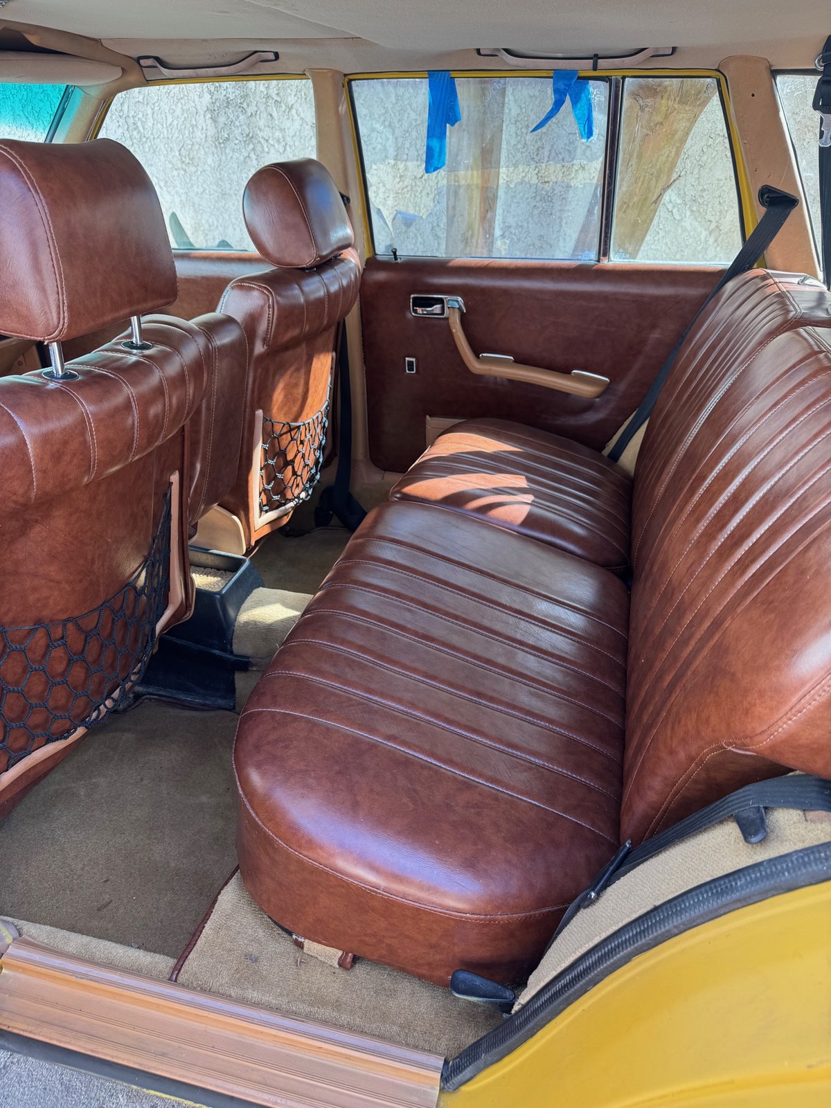 Same Mercedes rear seat after detail, rich conditioned leather
