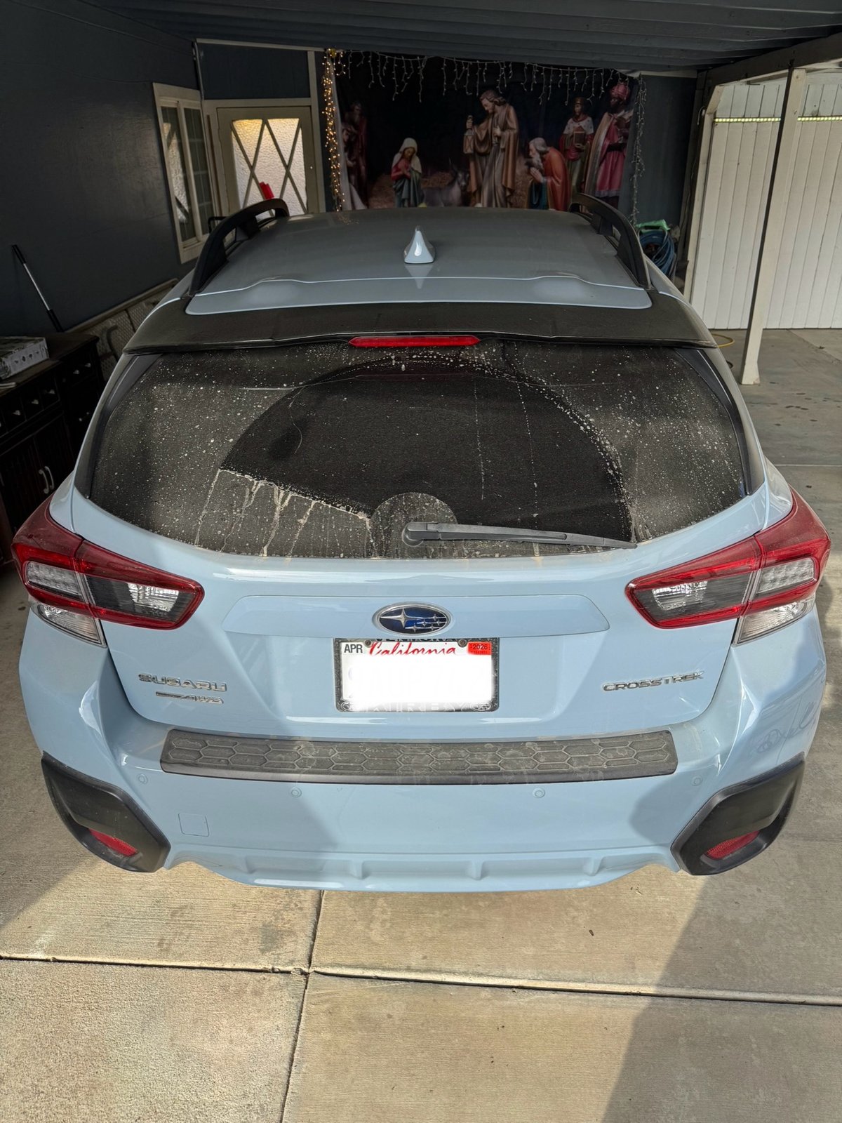 Subaru Crosstrek rear window before wash, covered in soap suds