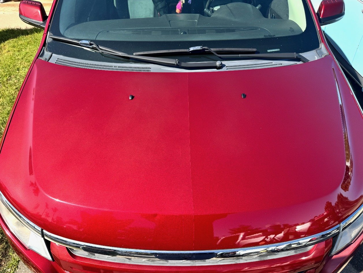 Red hood mid paint correction, dull swirled paint next to a sharp, glossy corrected half